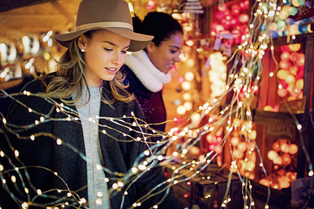 Women are choosing gifts and decoration at a Christmas market
