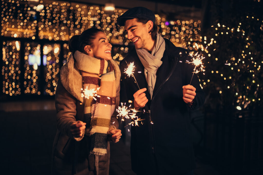 Couple holding sparklers outdoors