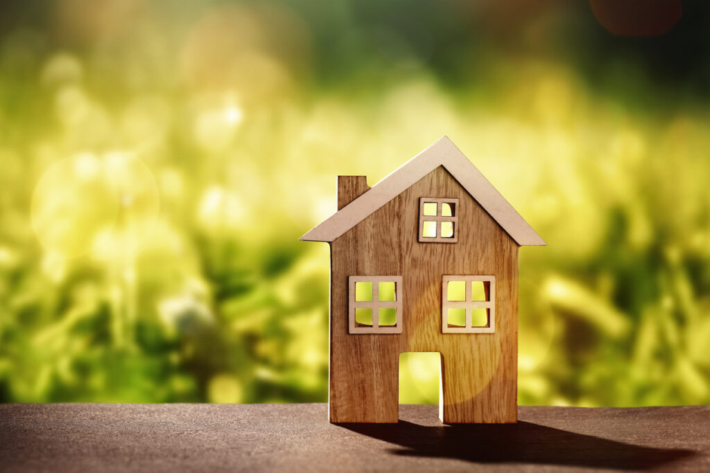 Wooden house on stone floor in front of nature background