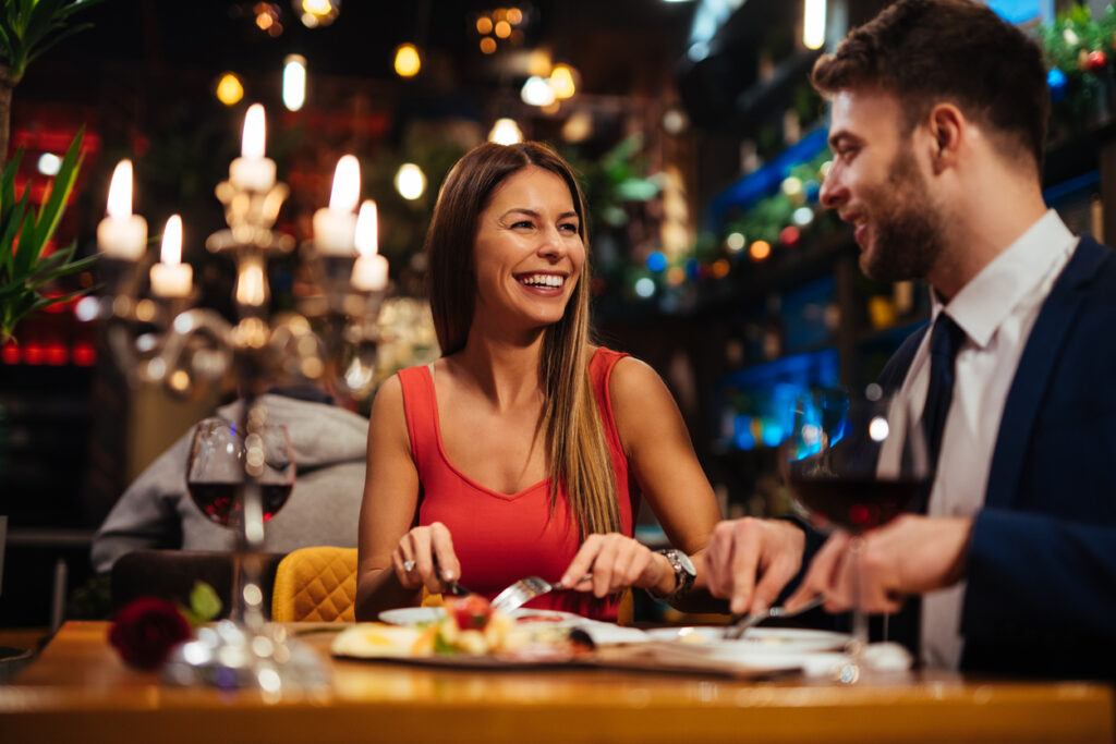 man and woman enjoying a romantic dinner at a restaurant