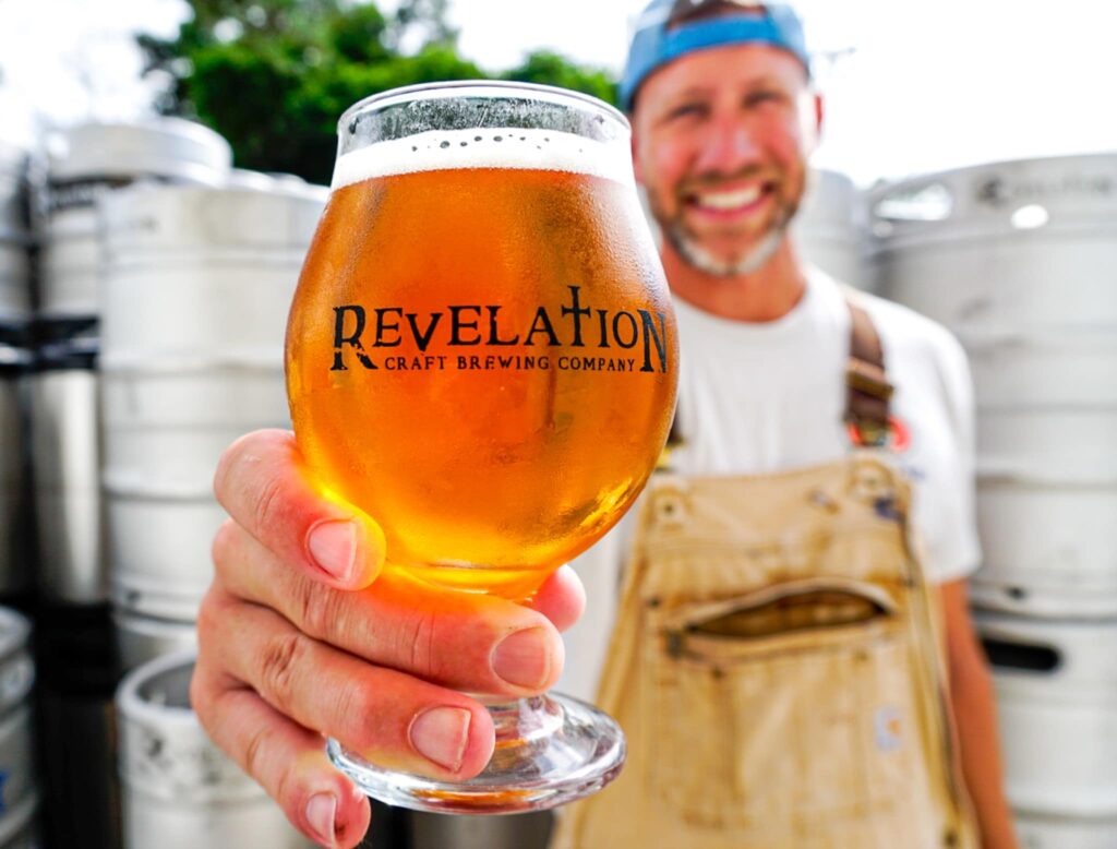 revelation craft brewing - man holding beer