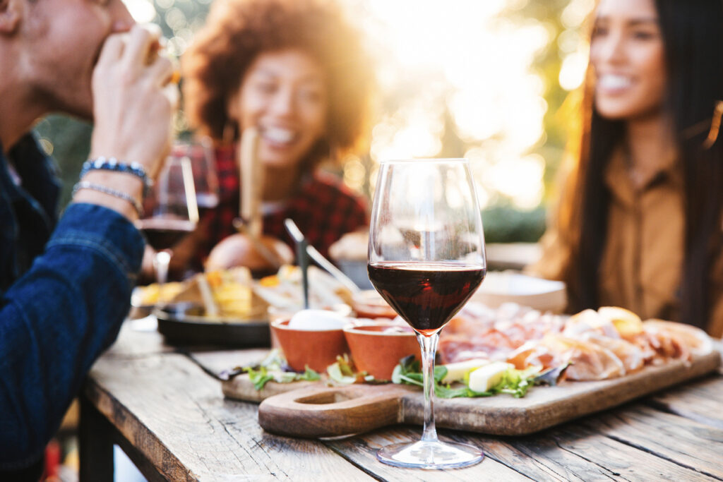 people enjoying eating at an outdoor restaurant