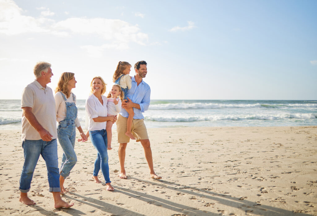 Multi-gen family walking on the beach