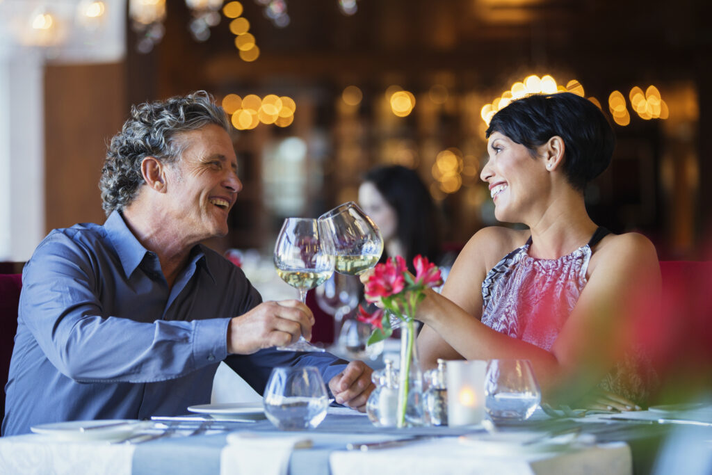 man and women drink wine in a nice restaurant