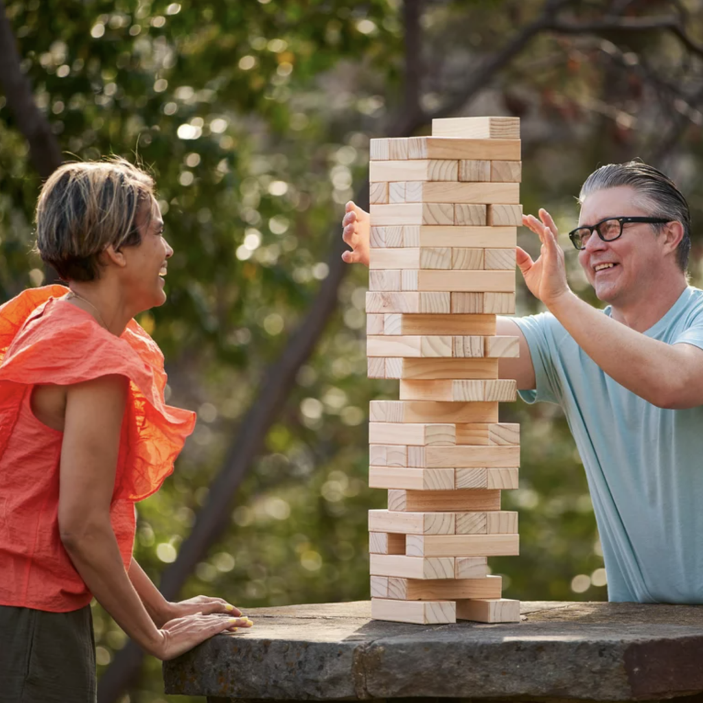 two people playing giant jenga outdoors