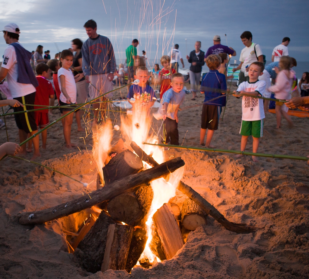 families enjoying bonfires on the beach at dewey beach