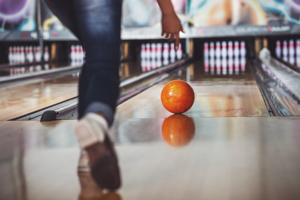 Woman bowling at bowling alley