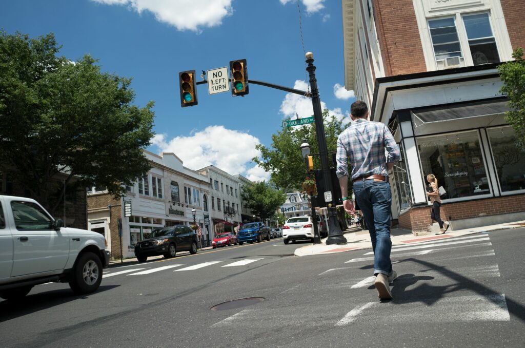a man crossing an intersection in doylestown, pa