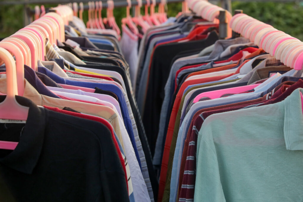 a rack of clothes from a thrift store