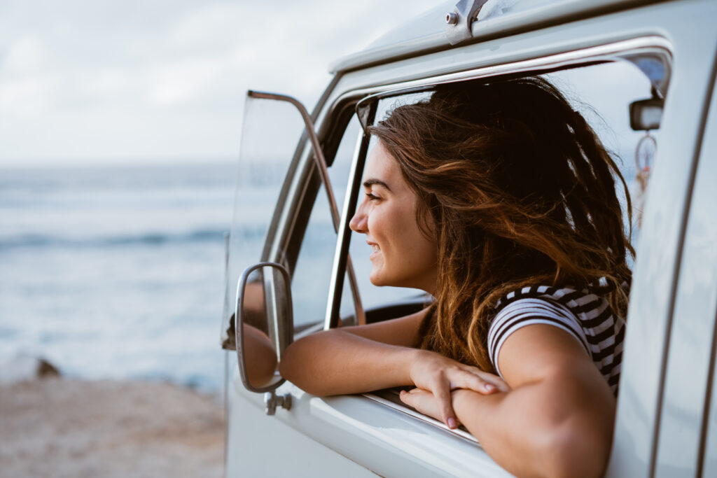 woman in a car on the beach