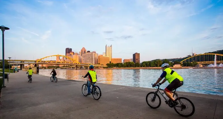 cyclists on the pittsburgh riverwalk