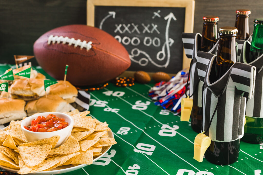 Game day football party table with beer, chips and salsa and decorations