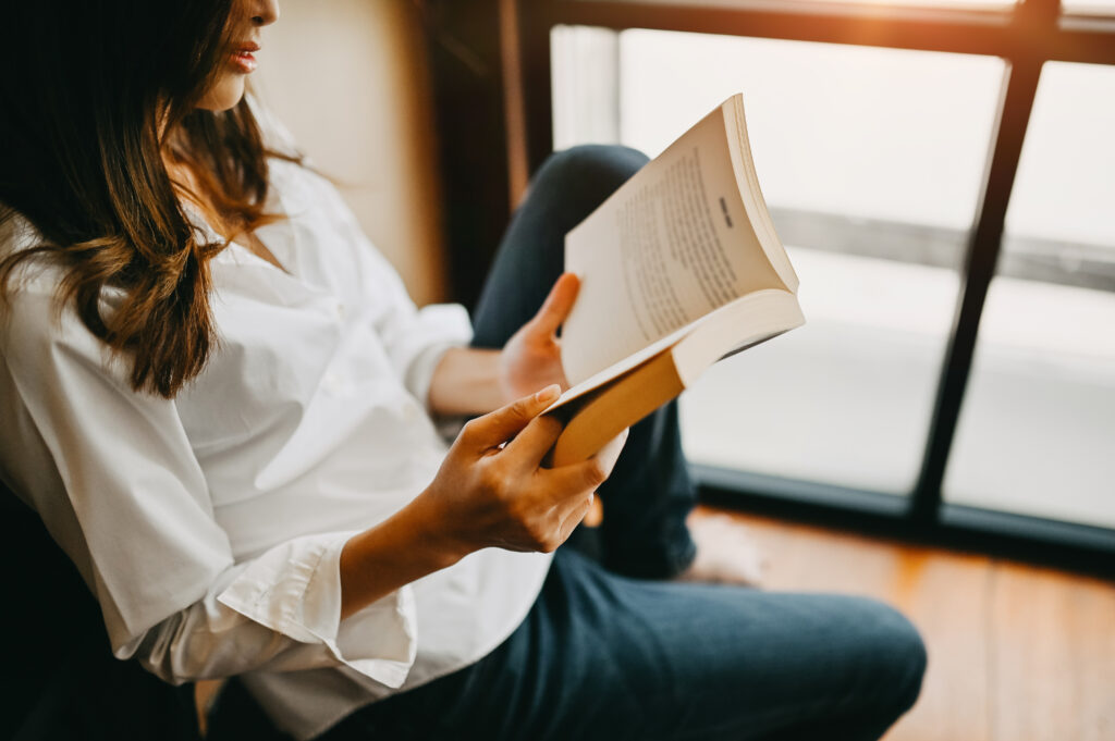 woman reading a book at home