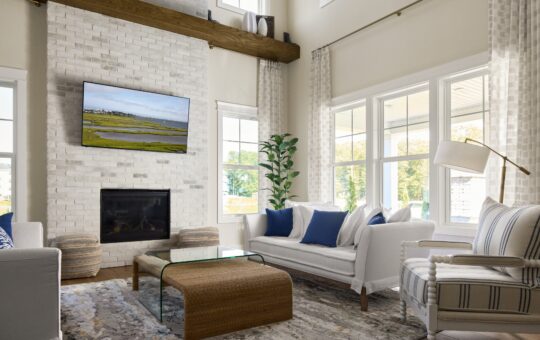 Bright living room with white brick fireplace, mounted TV, large windows, two white sofas with blue pillows, striped armchair, potted plant, glass coffee table with wicker base, and modern floor lamp.