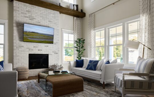 A bright, modern living room with white brick fireplace, wall-mounted TV, white sofas with blue pillows, a glass coffee table, large windows with curtains, and a tall plant in the corner.