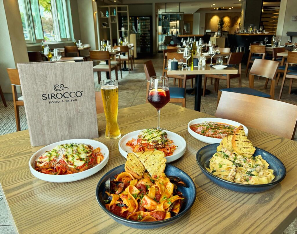 sirocco restaurant interior with multiple dinner dishes on one table