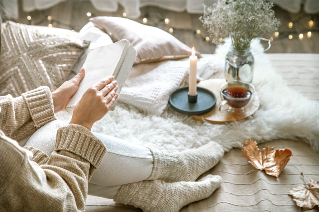 woman reading in a cozy space at home