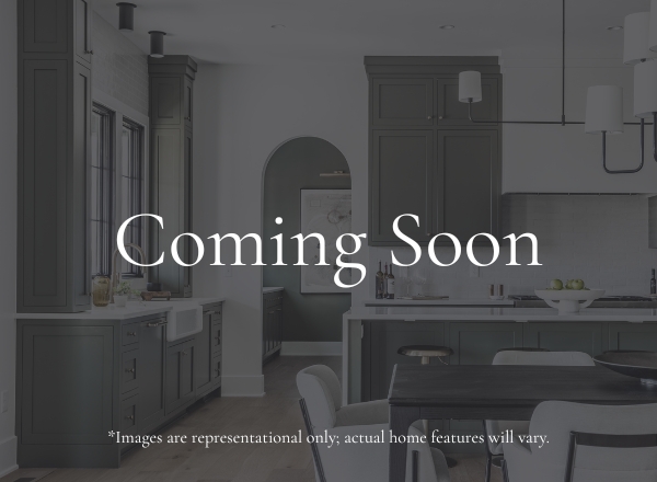 A modern kitchen and dining area with dark cabinets, a white island, and pendant lights. The text Coming Soon is overlaid, with a note that images are representational and actual home features may vary.