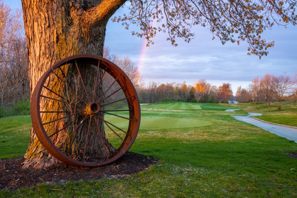 wagon wheel leaning on a tree at prairie view golf club