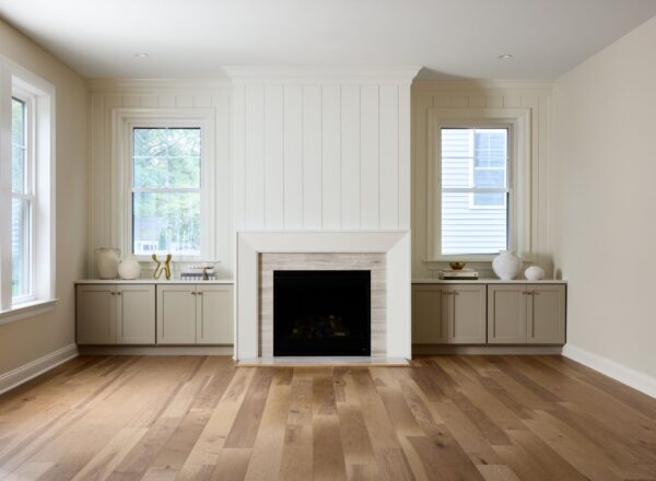 A room with a fireplace and windows.