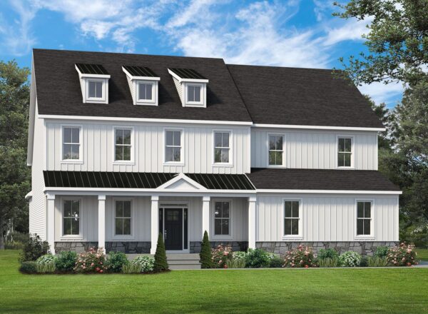 A modern two-story white house with black roof, three dormer windows, large front porch, and landscaped yard with green grass, shrubs, and flowers, set against a blue sky with scattered clouds.