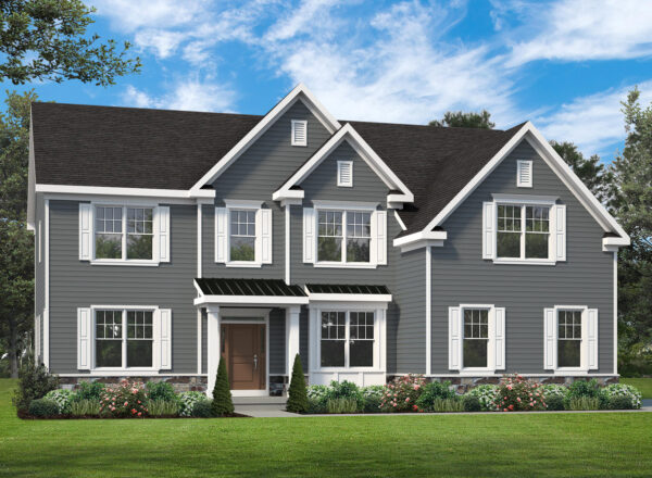 Two-story gray house with white trim, multiple windows, a brown front door, peaked rooflines, green lawn, bushes, and trees in the background under a blue sky with clouds.